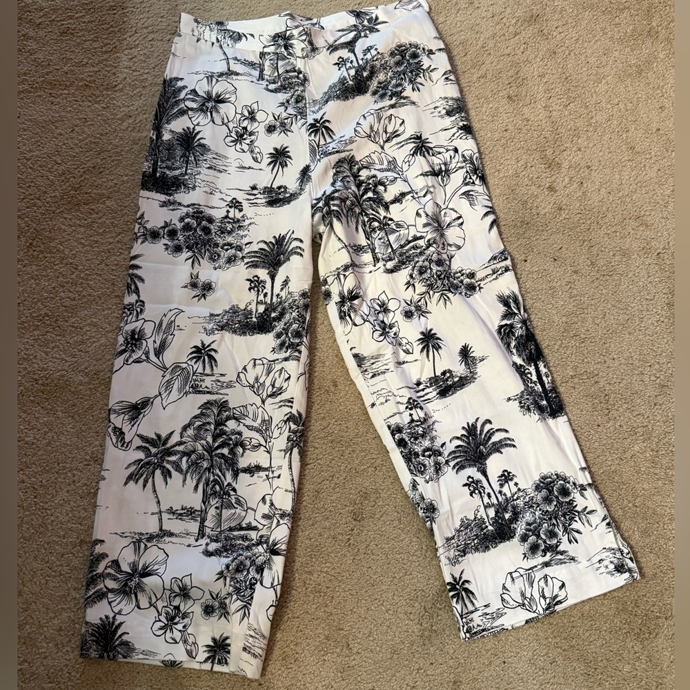 White pants with black tropical print.